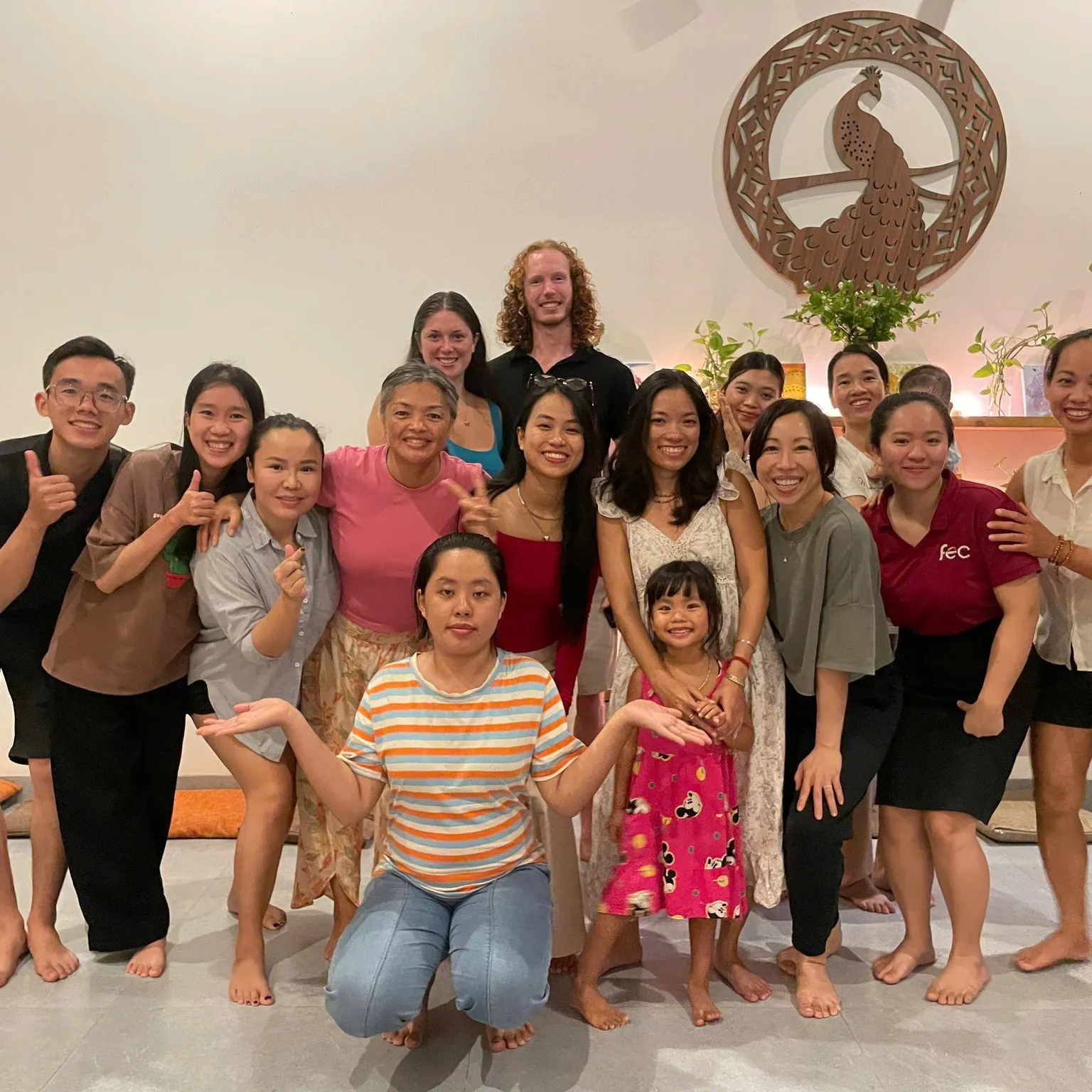 The whole community gathered close together, smiling after a session.