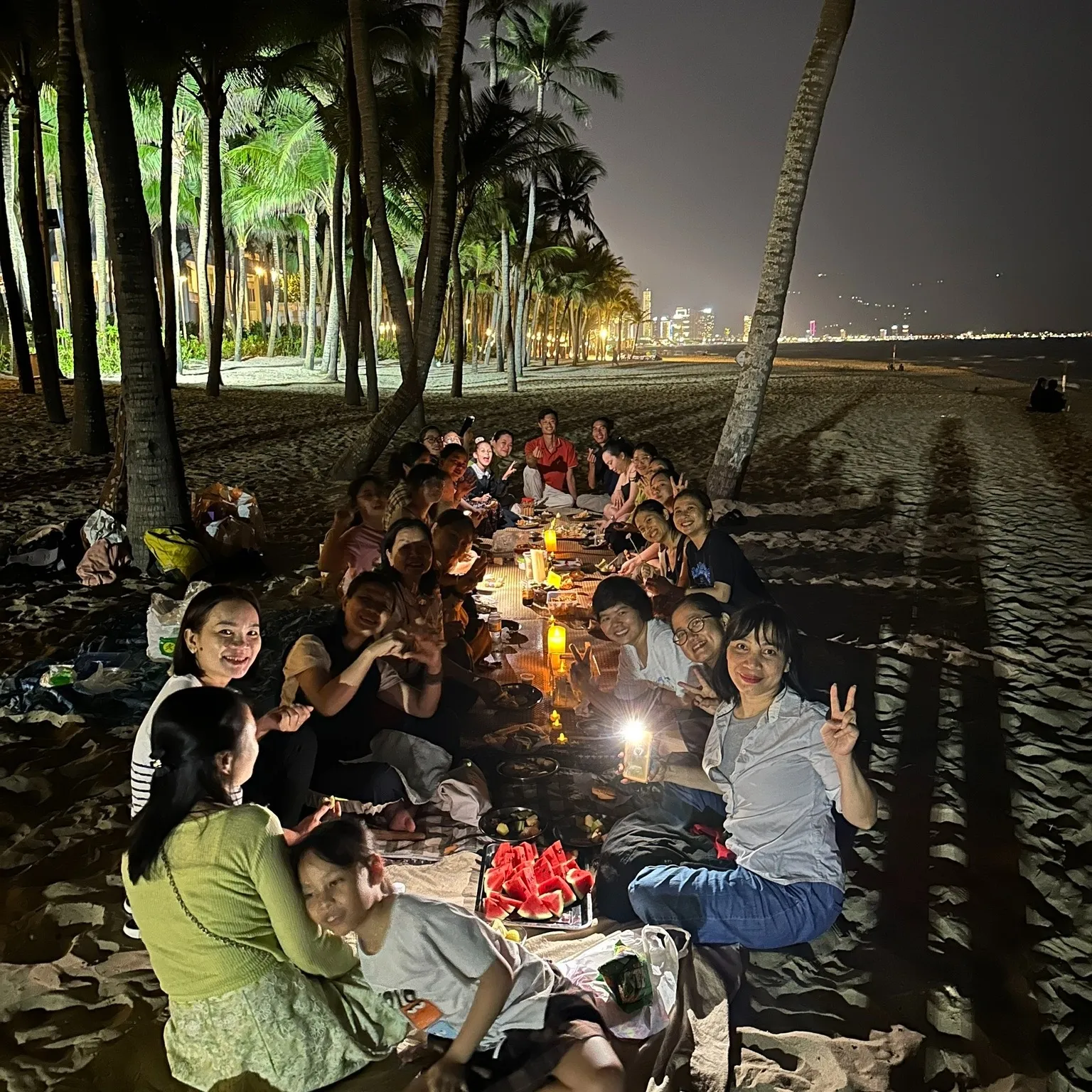 A long meal on the sand under the palms in the evening.