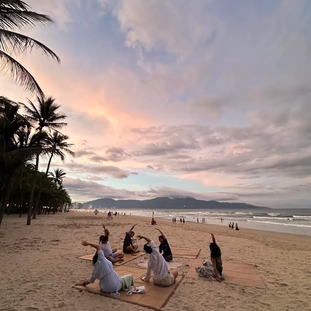 The group stretching on the beach at sunrise.